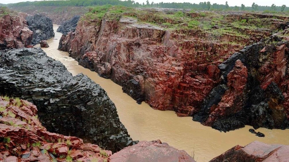 A river flowing through a canyon with steep, red rock walls. 2