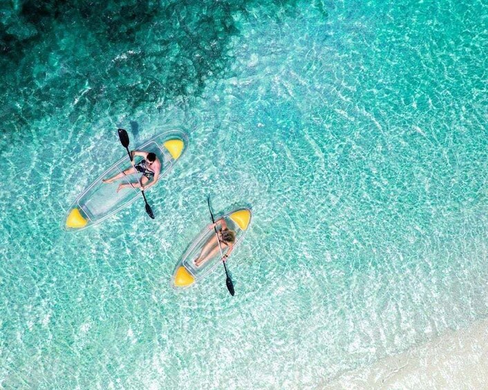 Two people kayaking on clear turquoise water. 1