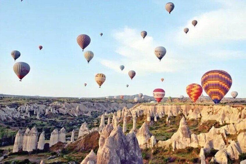 Hot air balloons over a rocky landscape with unique rock formations. 4