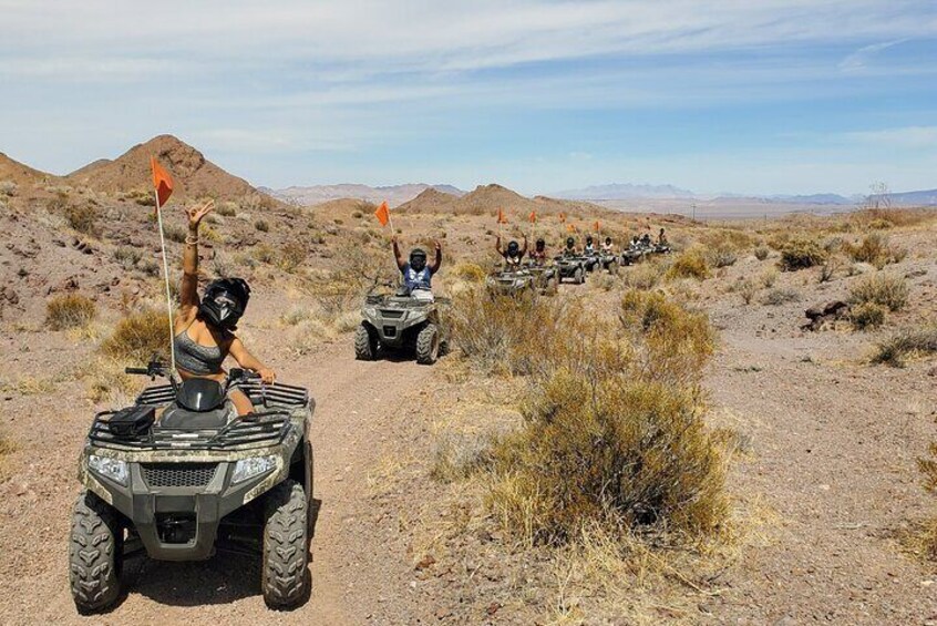 Off-road vehicles on a dirt path in a desert landscape. 3