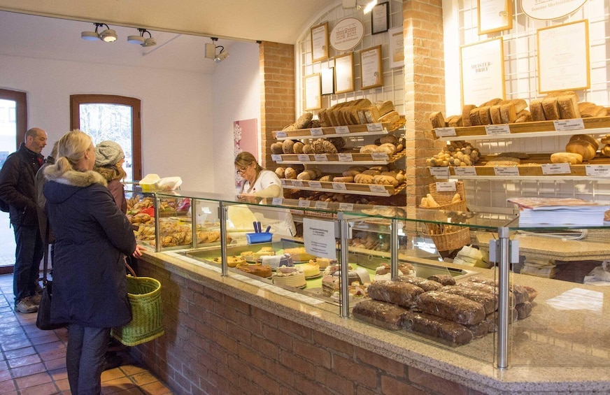A bakery display with various breads and pastries. 1