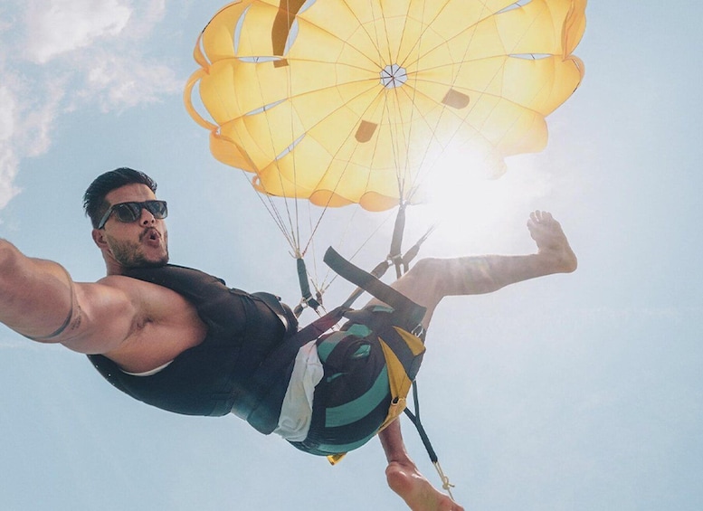 A person skydiving with a parachute. 1