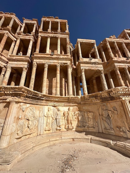 A large ancient stone structure with multiple columns and detailed carvings. 5