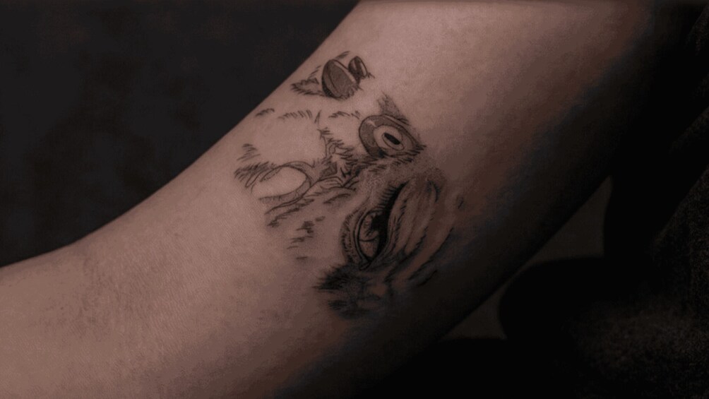 A tattoo of a bird on a person's arm. 2