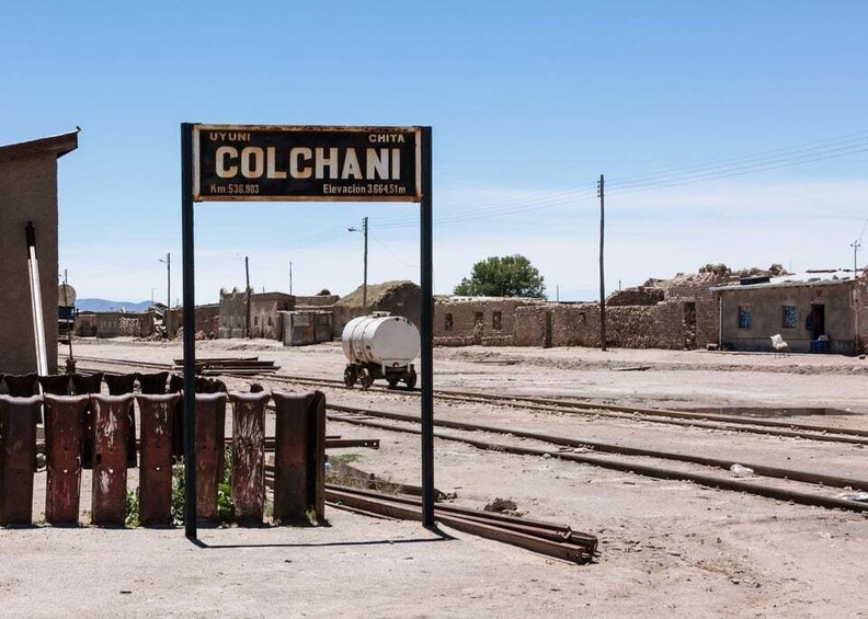 A signpost in a rural area with the text 'UYUNI COLCHANI' and 'Km 536.903'. 5