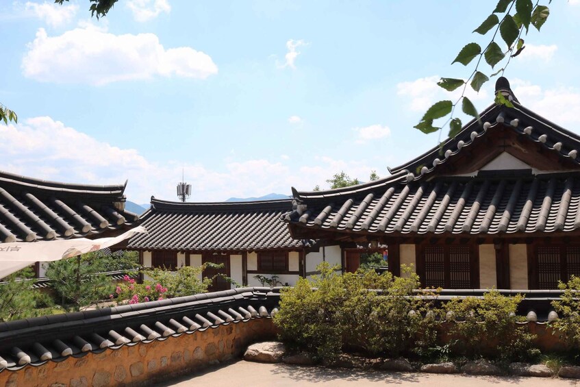 Traditional Korean architecture with curved tiled roofs and stone walls. 4