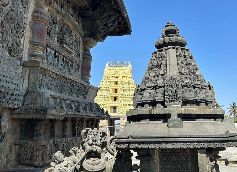 A temple with intricate carvings and a large, ornate structure in the background. 2