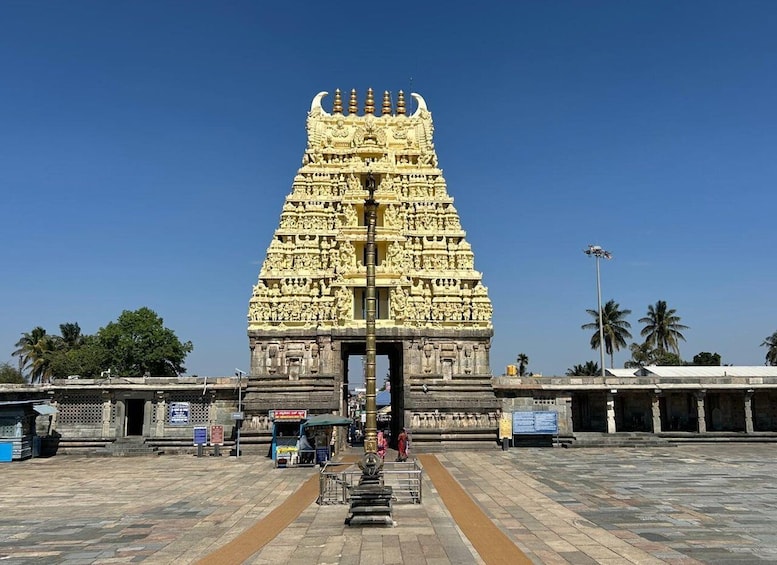 A detailed temple entrance with intricate carvings and a clear sky. 3
