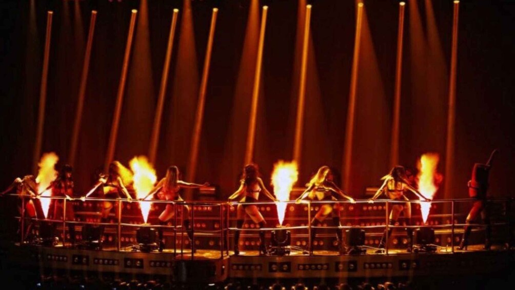 A stage with performers and fire effects. 4