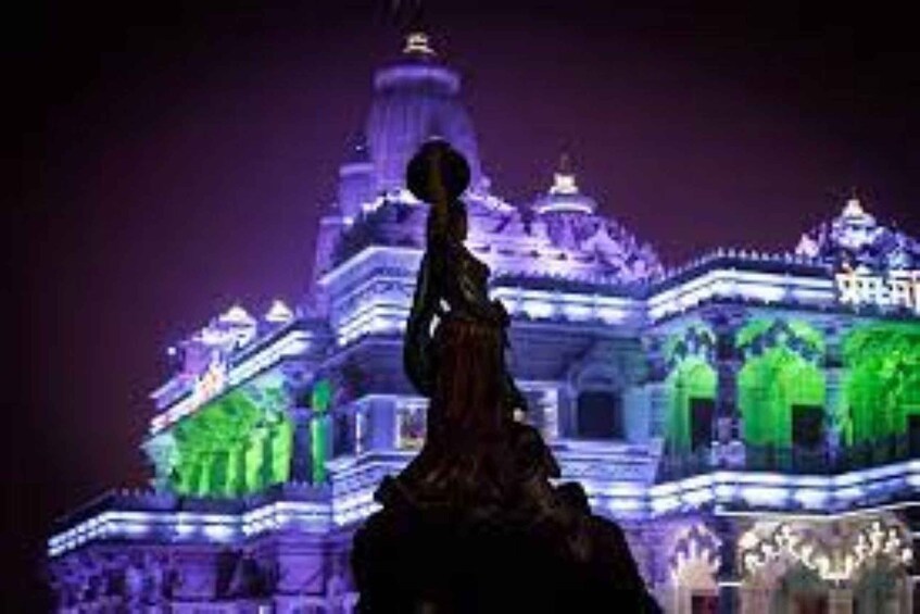 A temple with illuminated green and purple lights. 4