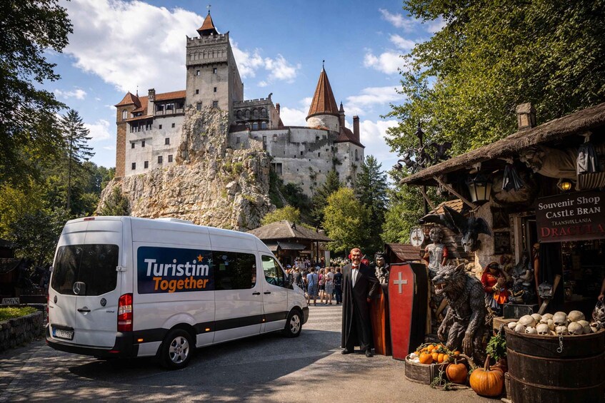 A castle, a van, and a shop with pumpkins. 1