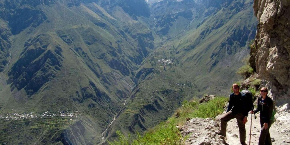 A mountainous landscape with a valley and a small settlement. 5