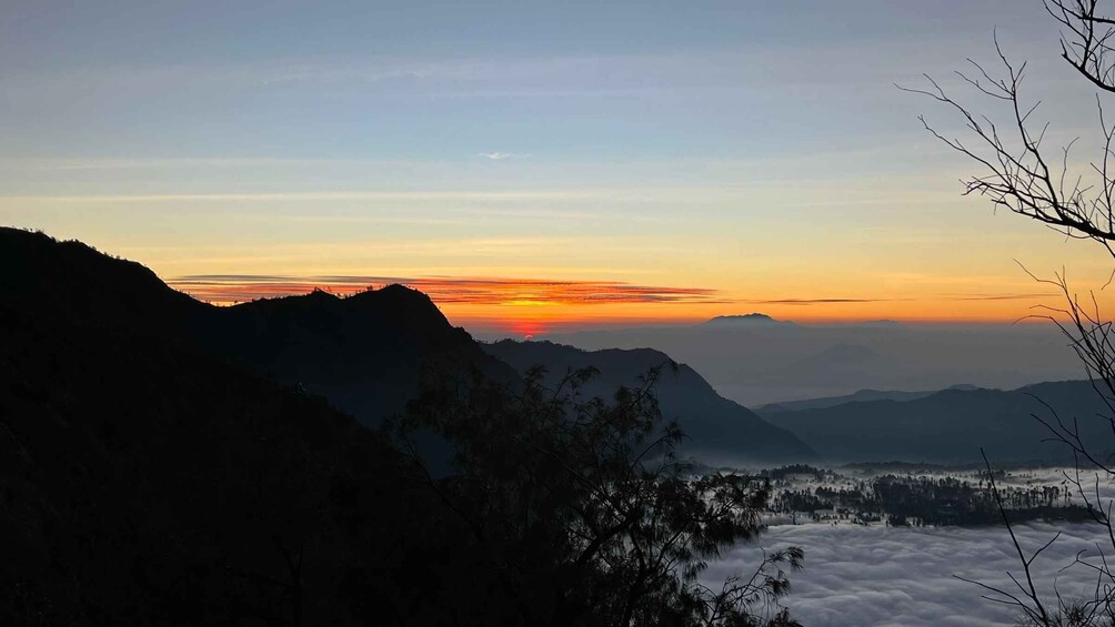 A mountainous landscape at sunrise with a clear sky. 5