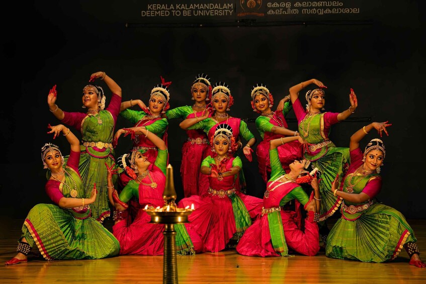 A group of dancers in traditional attire performing on stage. 3