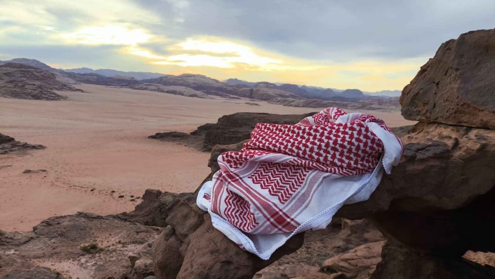 A desert landscape with a rocky outcrop and a blanket on it. 3