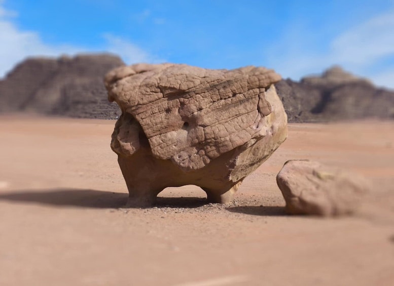 A large rock formation in a desert landscape. 5