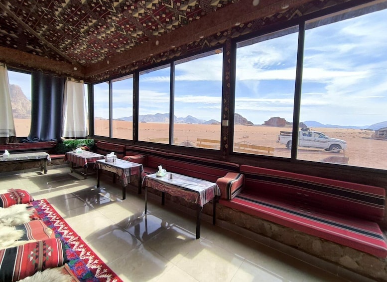 A room with large windows overlooking a desert landscape. 1
