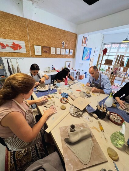 A pottery workshop with participants engaged in crafting pottery. 1