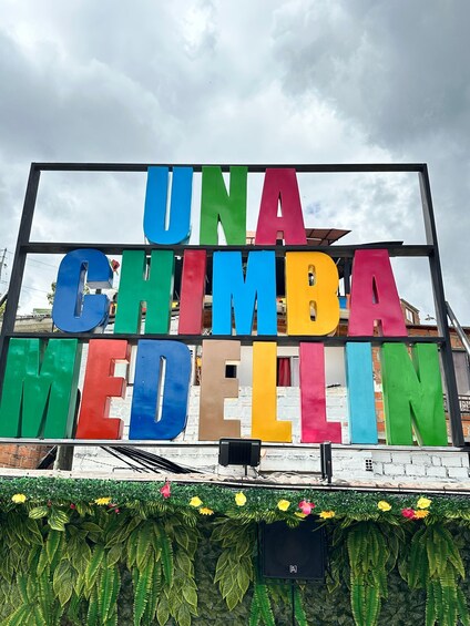A colorful sign with 'UNA CHIMBA MEDELLIN' written in large letters. 2