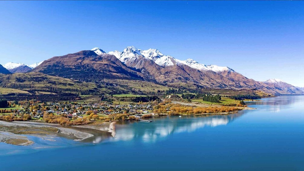 A lake with mountains in the background and a town in the foreground. 4