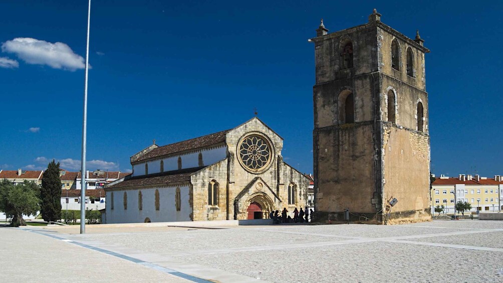 A historic church with a large circular window and a bell tower. 3