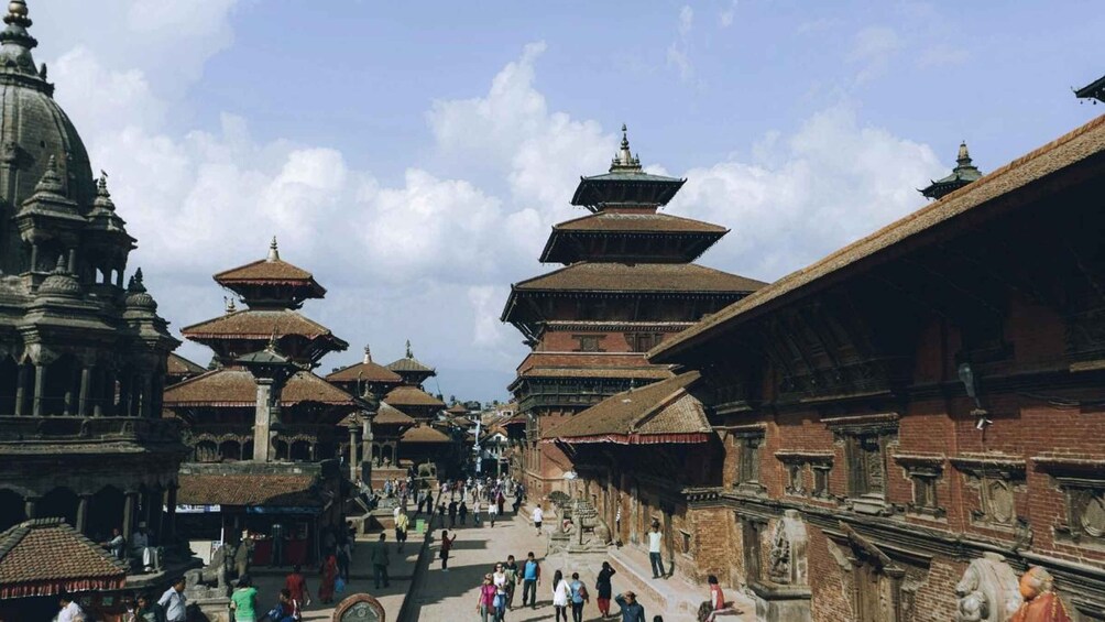 A street lined with traditional multi-tiered buildings and a large domed structure. 3