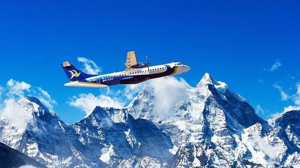 An airplane flying over snow-capped mountains. 2