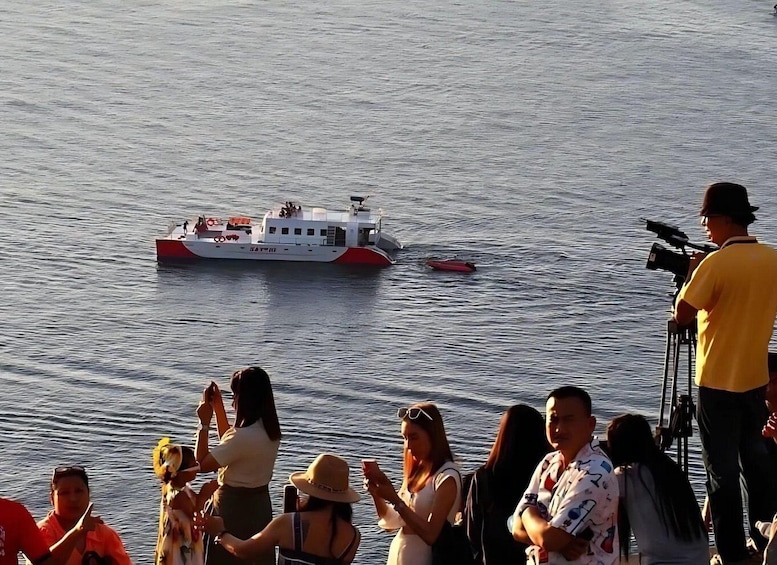A boat on water with people on the shore. 4