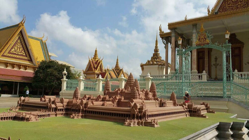 A temple complex with ornate golden roofs and intricate stone carvings. 1