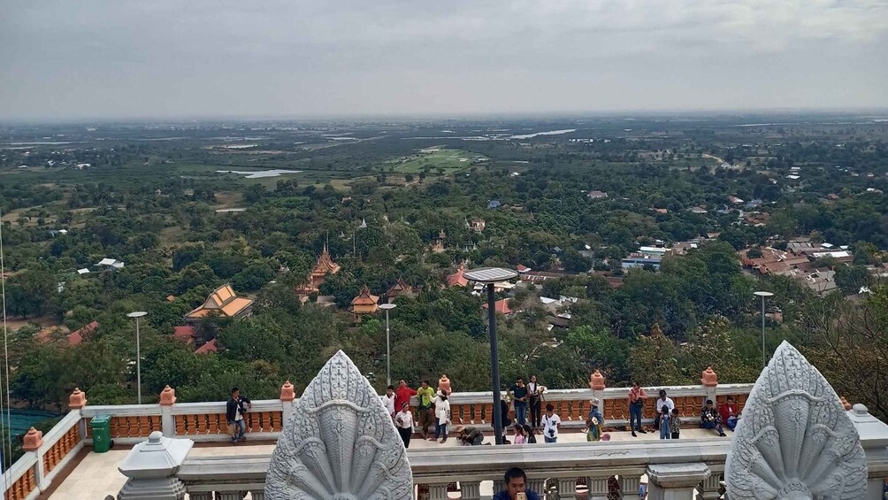 A panoramic view of a landscape with a temple complex and surrounding greenery. 2