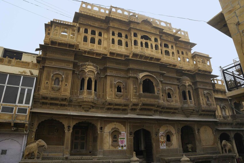 A historic building with intricate carvings and multiple balconies. 4