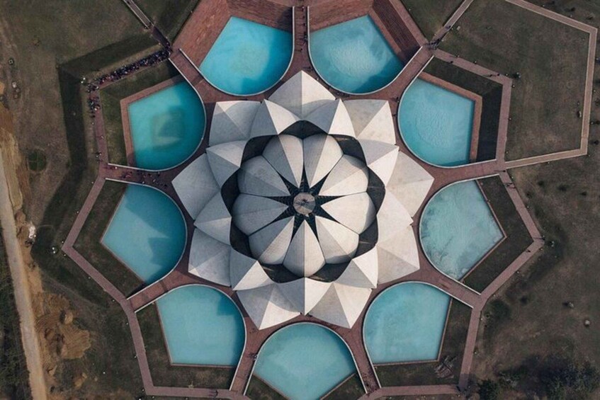 An aerial view of a geometric pool arrangement with a central star-like pattern. 3