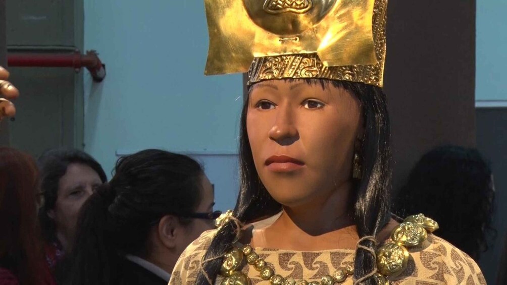 A person wearing a traditional headdress and ornate jewelry. 1
