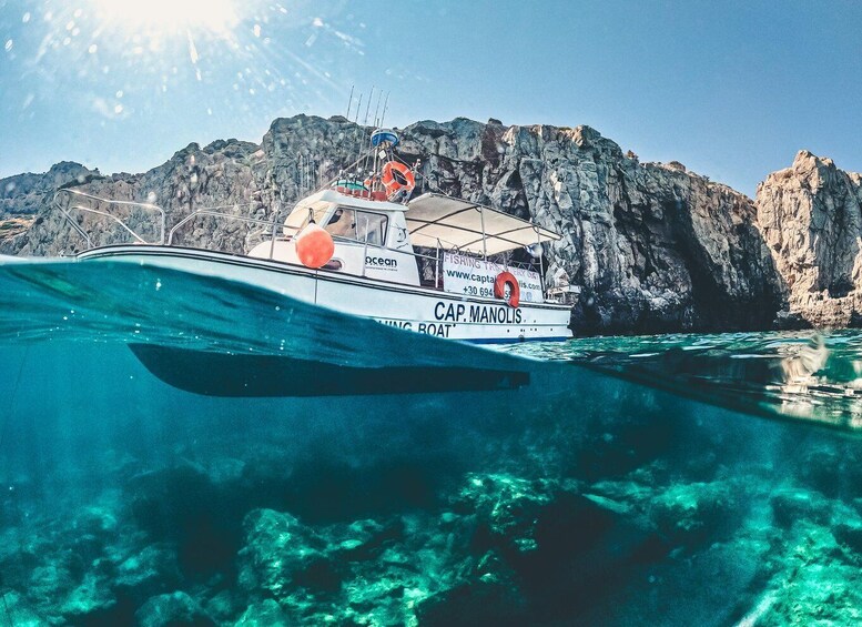 A boat named 'Carmarolis' with a rocky backdrop. 1