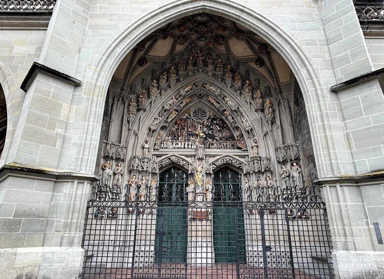 A Gothic church facade with intricate sculptures and a green door. 5