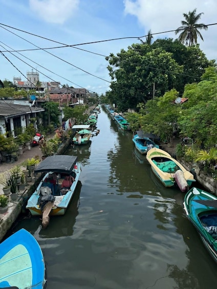 A narrow waterway lined with small boats and houses. 2