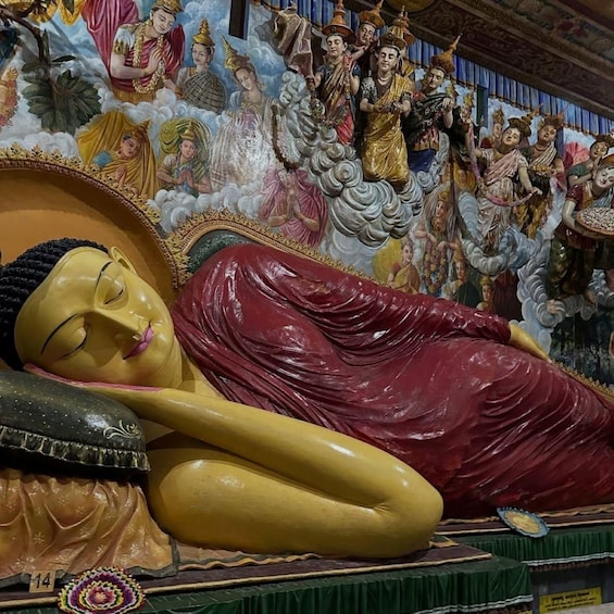 A large statue of Buddha lying down with a backdrop of other statues and figures. 3