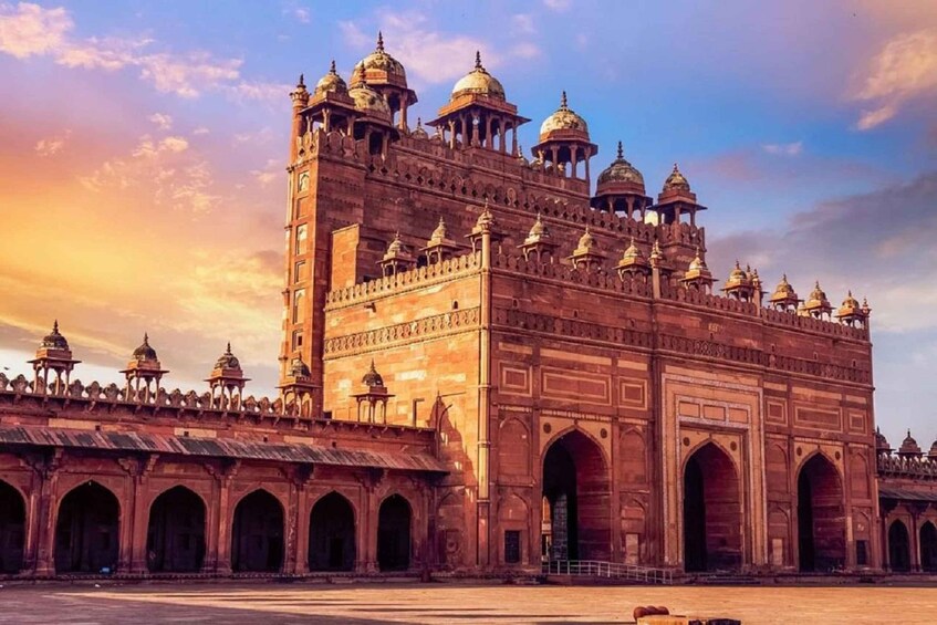 A large, ornate building with multiple domes and arches, likely a historical or cultural landmark. 1