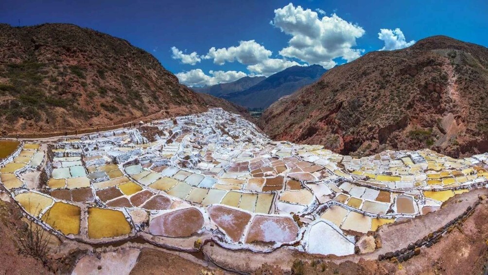 Terraced salt flats with a mountainous backdrop. 4