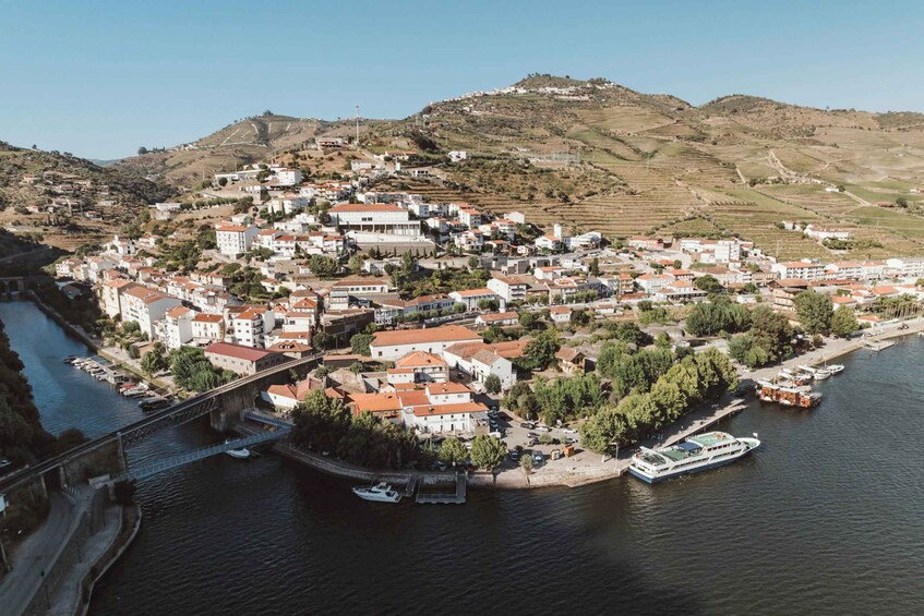A coastal town with a river, a bridge, and boats. 3