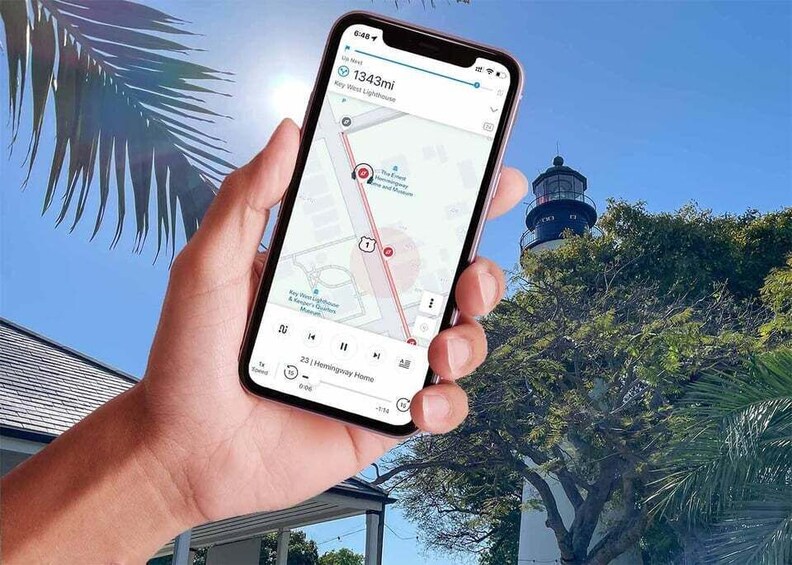 A hand holding a smartphone with a map application displaying a route to Key West Lighthouse, 1343 miles away. 4
