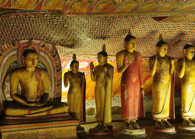 Golden Buddha statues in a temple with intricate ceiling patterns. 3