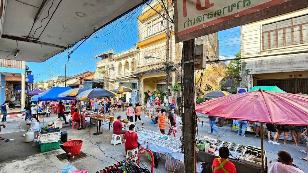 A bustling street market with vendors and shoppers. 5