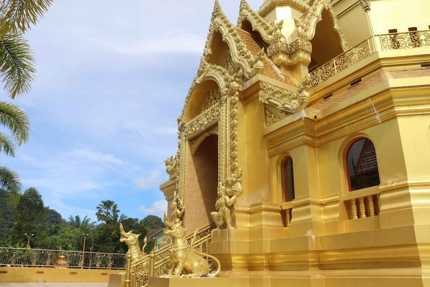 A golden temple with intricate carvings and a lion statue. 2