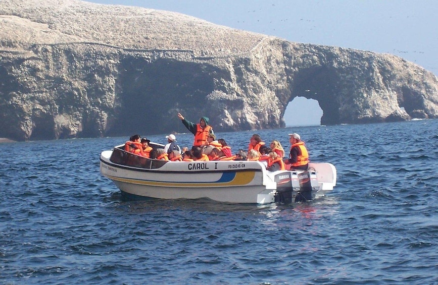 A boat named CAROL I with people wearing life jackets on the water. 3