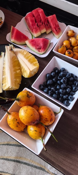 A table with various fruits including watermelon, pineapple, blueberries, and citrus fruits. 5