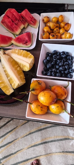 A table with various fruits including watermelon, blueberries, and mangoes. 4