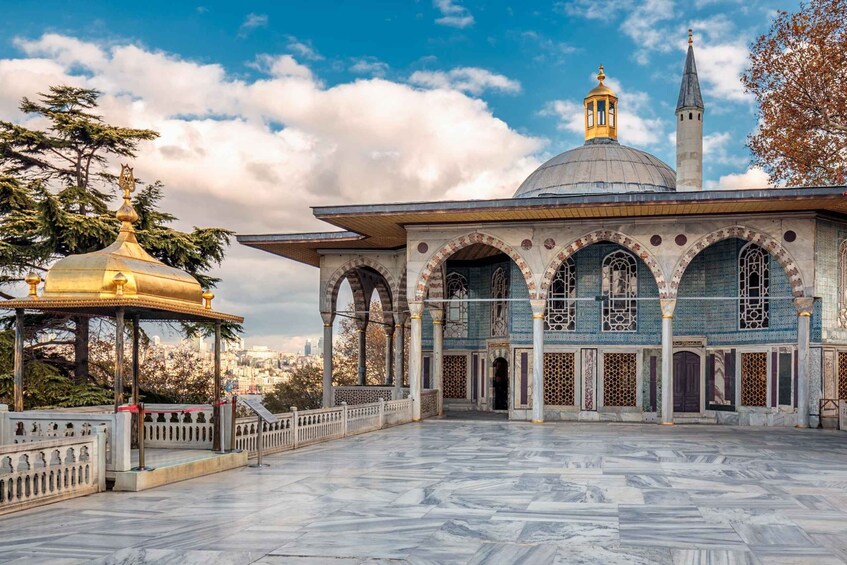 A mosque with a large dome and minarets, surrounded by a marble courtyard with a gazebo. 3