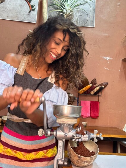 A person operating a coffee grinder. 3