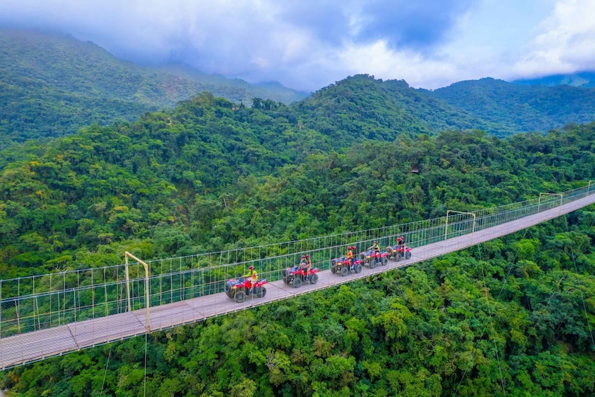 A suspension bridge with vehicles and people. 4